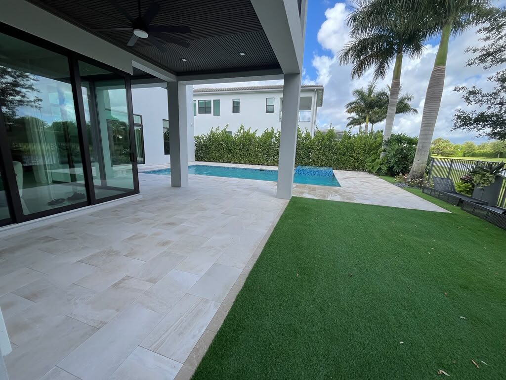Home exterior and covered patio by Forben Construction